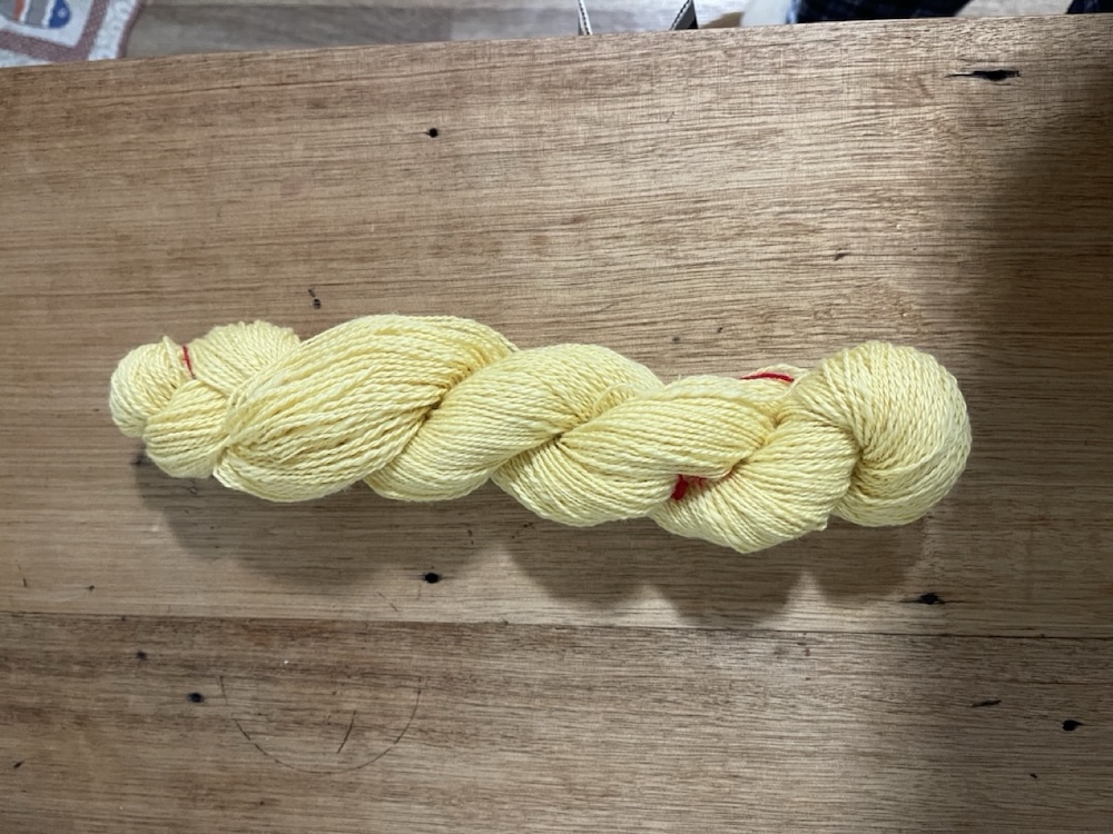 yellow merino yarn on a skein